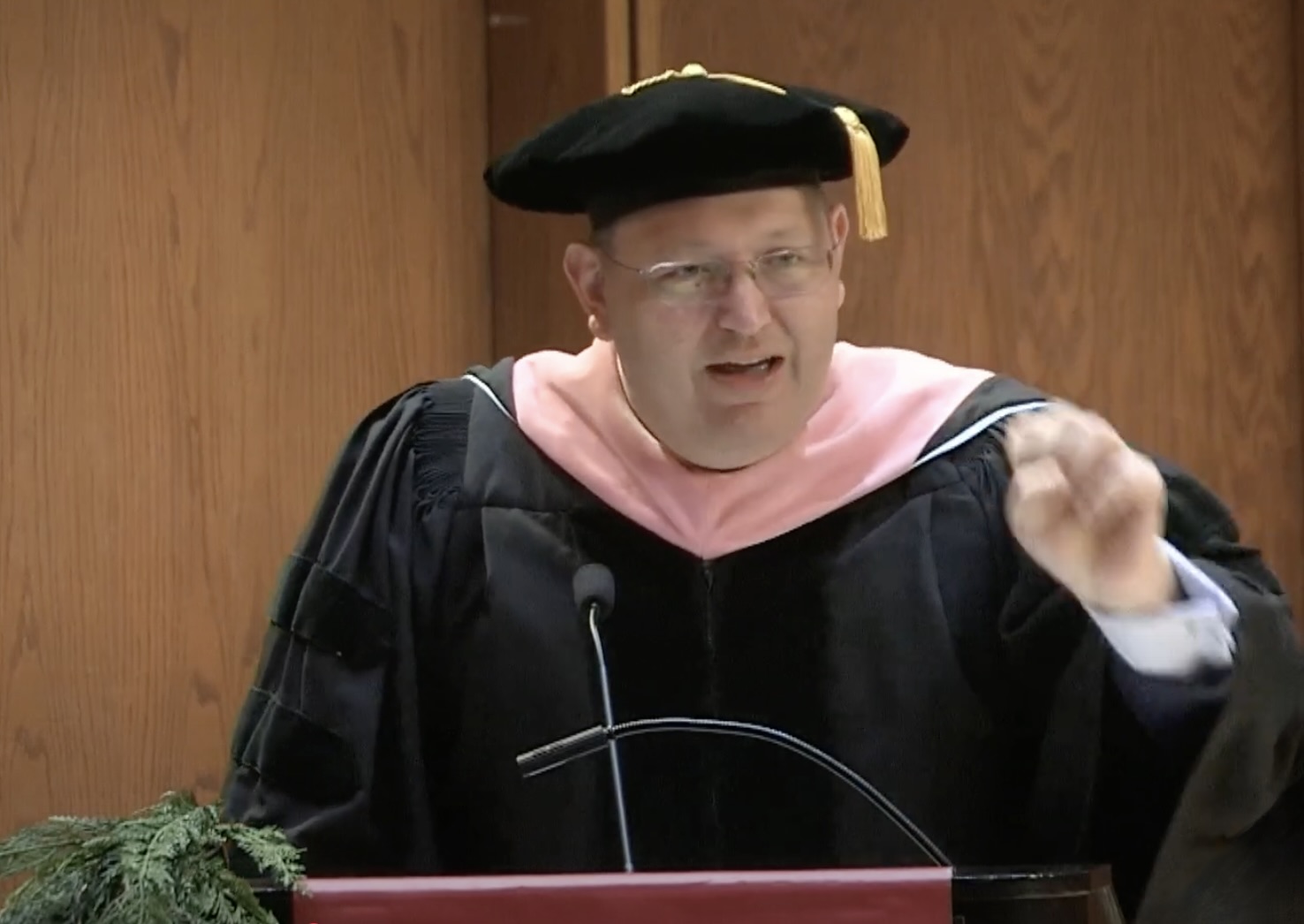 Dr. Brian Castrucci stands at a lectern addressing the graduates of the University of Nebraska Medical Center’s College of Public Health.